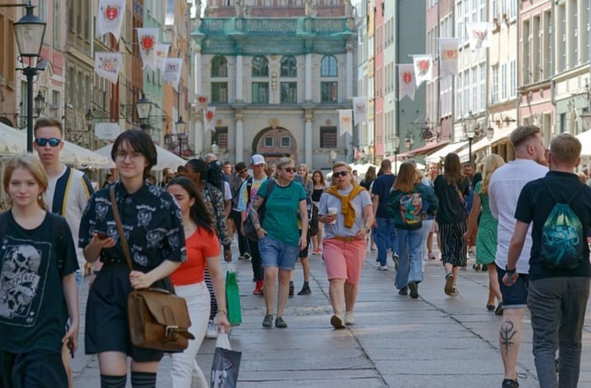 A busy pedestrian street filled with people walking and enjoying their day, perfect for those planning to spend a weekend in Jackson Heights, NY.